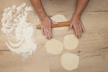 Rolling out the dough with your hands.
