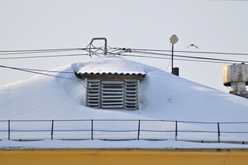 Dormer window on the roof of an old house on a winter day
