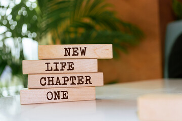 Wooden blocks with words 'New Life Chapter One'.