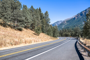 Fototapeta premium Enthusiast cyclist conquers a mountain highway while cycling in Columbia Gorge