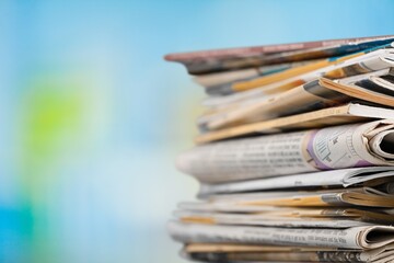 A pile of dusty, old magazines on background