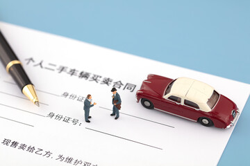 Miniature scene used car transaction sign the contract