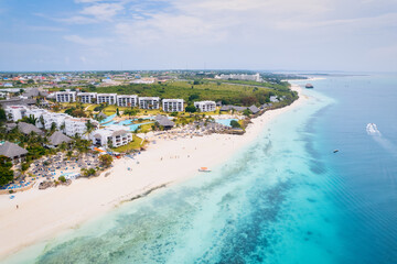 Fototapeta na wymiar Aerial drone photography captures the breathtaking beauty of Zanzibar's crystal clear waters and white sandy beaches in Nungwi.