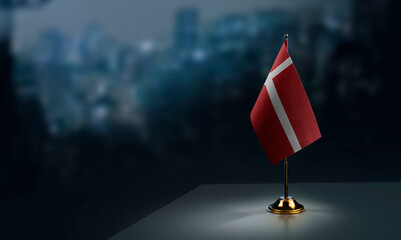A small Denmark flag on an abstract blurry background