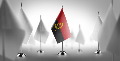 The national flag of the Angola surrounded by white flags