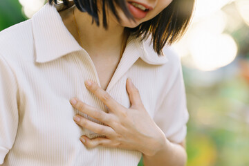 A woman has chest pain due to acute heart failure. Health care concept.