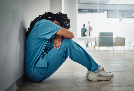 Doctor, depression and stress with black woman on floor for patient loss, surgery fail or death in hospital. Mental health, sad or anxiety for healthcare worker nurse in medical community clinic