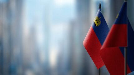 Small flags of the Liechtenstein on an abstract blurry background - obrazy, fototapety, plakaty
