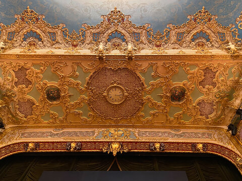Venice, Italy - February 17, 2023: clock and decor on ceiling in hall of opera house Gran Teatro la Fenice in Venice city