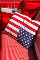 Pillow with American flag in the back seat in an old classic car