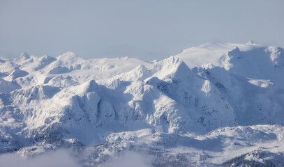 Obraz premium Snow and Cloud covered Canadian Nature Landscape Background. Winter Season in Whistler, British Columbia, Canada. From Blackcomb Mountain