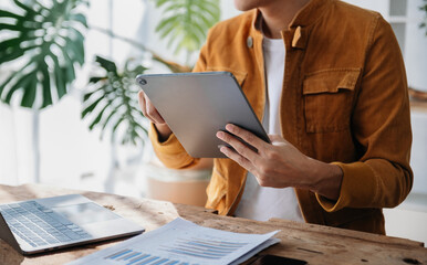 businessman hand working with new modern computer using on smartphone and tablet as concept
