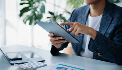Businesswomen analyzing investment graph and discussing plan new start up project. Finance task..