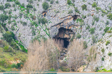 cave in the mountain with the railroad in the foreground