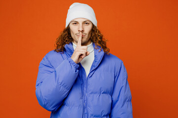 Young secret man with long curly hair wearing hat purple ski padded jacket casual clothes says hush...