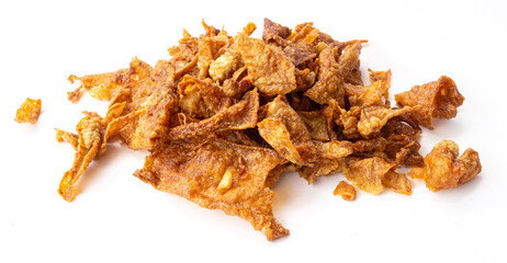 Crispy fried chicken skin on white background, snack food.