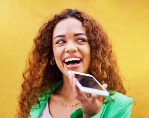 Phone, loudspeaker and woman talking on yellow background, color wall and backdrop. Trendy female,...