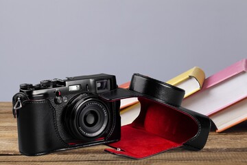 Old fashioned camera on bookshelf with retro books