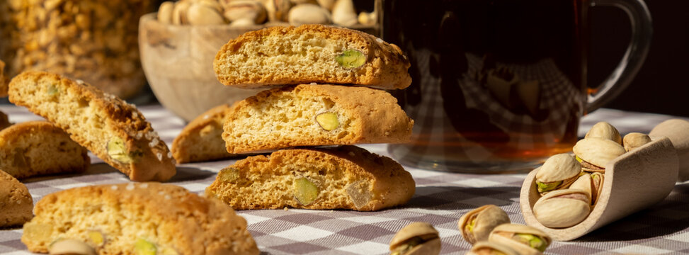 Biscotti Cantuccini Cookie Biscuits with pistachios and lemon peel Shortbread. Cup of tea. Teatime break Healthy eating food. Homemade fresh Italian cookies cantucci stacks and organic pistachios nuts