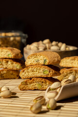 Biscotti Cantuccini Cookie Biscuits with pistachios and lemon peel Shortbread. Healthy eating food. Homemade fresh Italian cookies cantucci stacks and organic pistachios nuts. Vegan dieting