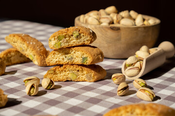 Biscotti Cantuccini Cookie Biscuits with pistachios and lemon peel Shortbread. Healthy eating food. Homemade fresh Italian cookies cantucci stacks and organic pistachios nuts. Vegan dieting