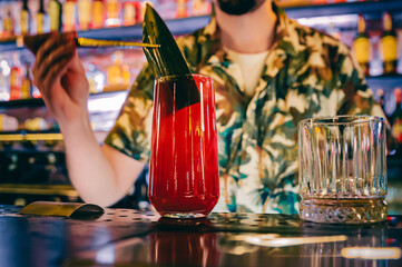 man hand bartender making cocktail in glass on the bar counter