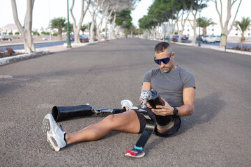 Runner with disability putting on blade leg prosthesis