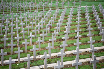 Endless crosses at the cemetery outside the Douaumont ossuary (L'ossuaire de Douaumont) built in 1932 is a memorial containing the remains of soldiers who died at the battle of Verdun 21 February 1916 - obrazy, fototapety, plakaty