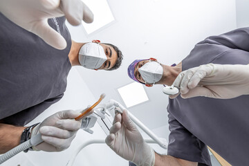 Dentist and assistant ready to treat patient