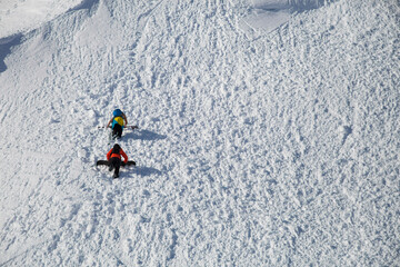 Backcountry skiers bootpacking up snowy hill, North Cascades National Park, Washington State, USA