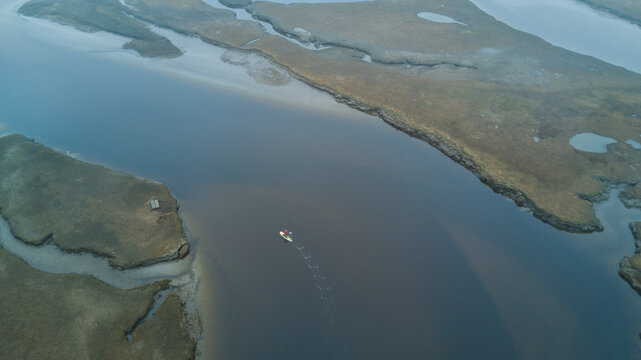 Aerial view of paddleboarder surfing in Scarborough Marsh, Maine, USA