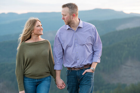 Couple holding hands with ridgeline of the Coburg Hills in background, Horse Rock Ridge, Marcola, Oregon, USA