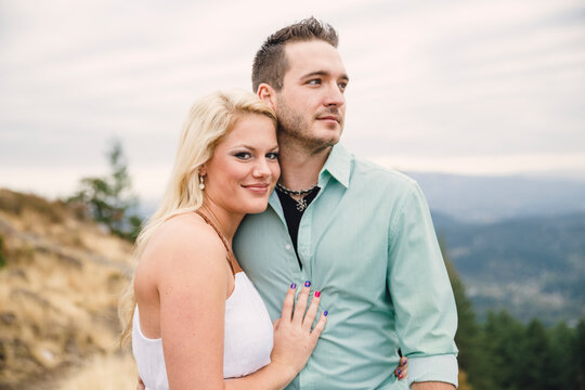 Portrait of young couple hugging on top of hill during daytime, Eugene, Oregon, USA