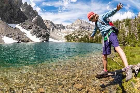 Girl balancing on log while hiking to Merriam Lake Basin, Upper Pashimeroi Valley, Lost River Range, Challis, Idaho, USA