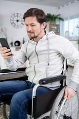 disabled man in the home looking at smartphone