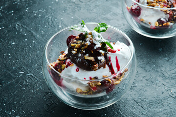Ice cream with chocolate, cherry toppings, in a glass creamer. Restaurant menu. Rustic style.