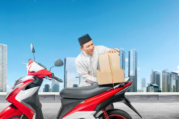 Asian Muslim man tying box on motorcycle prepare for mudik