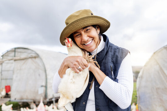 Chicken farmer, woman and smile for agriculture in field, environment and countryside. Portrait of worker, poultry farming and animal birds for sustainability, eggs production and food trade industry