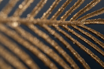 Gold palm leaf on black background