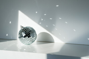 Disco ball in sunlight on white background