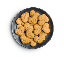 Sweet gingerbread hearts on plate isolated on white background.