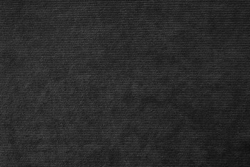 Fototapeta na wymiar Texture background of velours black fabric. Upholstery velveteen texture fabric, corduroy furniture textile material, design interior, decor. Ridge fabric texture close up, backdrop, wallpaper.