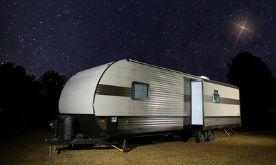 Bright light in the night sky above a trailer