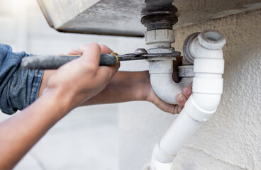 Hands, tool and pipe with a man plumber fixing a water system as a DIY handyman for maintenance. Building, construction or plumbing with a professional contractor working to install pipeline drainage