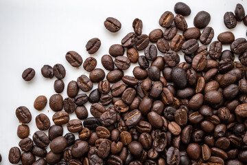 Fresh roasted brown coffee beans on white background