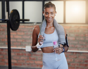 Woman, fitness and portrait smile with water bottle and sweat towel for exercise, workout or training at gym. Happy female smiling with drink for refreshment, hydration or healthy cardio wellness - obrazy, fototapety, plakaty