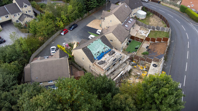 Aerial photo of a typical housing estate in Birkby close to the town centre in Huddersfield, in the Kirklees borough of West Yorkshire showing construction work being done on one the houses