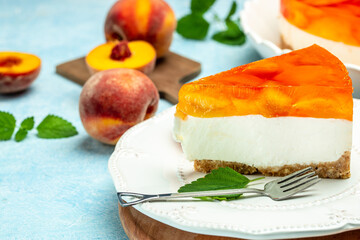 Tasty cheesecake with fruit peaches, peache jelly, jam on a light background