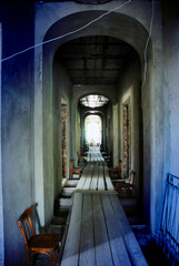 A long corridor with a wooden floor in an old Orthodox monastery