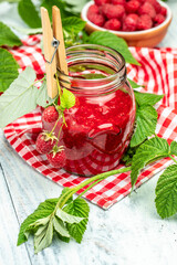 homemade raspberry jam or confiture on light background. vertical image. top view. place for text